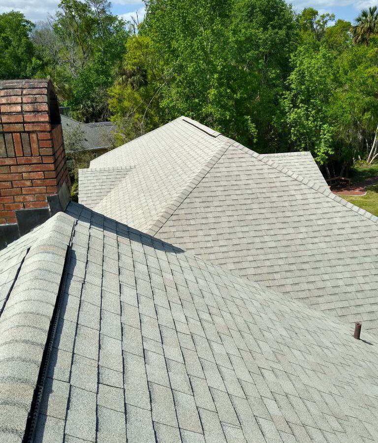 Before and after comparison showing Roof cleaning near me in DeLand, FL on a shaded residential roof Before and after comparison showing Roof cleaning near me in DeLand, FL on a shaded residential roof