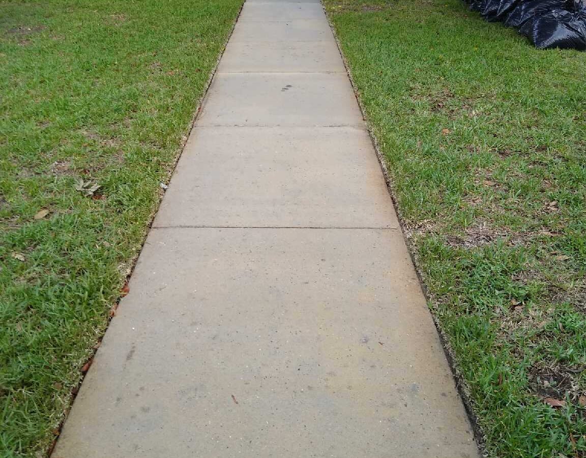 Home exterior refreshed through Maintenance Cleaning near me in Winter Garden, FL with spotless walkways and siding
