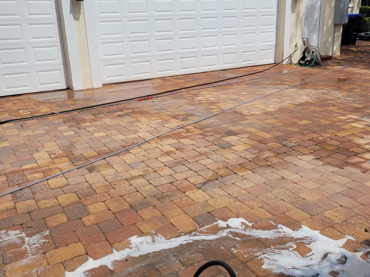 Homeowner receiving maintenance cleaning near me in Windermere, FL for patios, siding, and walkways
