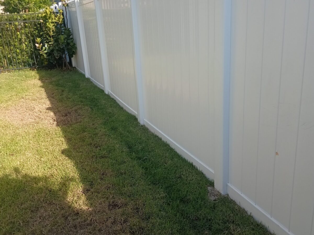 Residential crew providing maintenance cleaning near me in DeLand, FL around a driveway, garden border, and side entrance