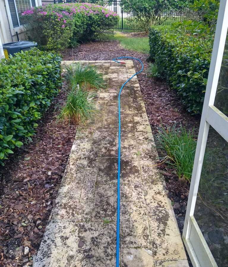 Waterfront patio refreshed after Maintenance Cleaning in Tavares, FL with clean pavers and an inviting seating area