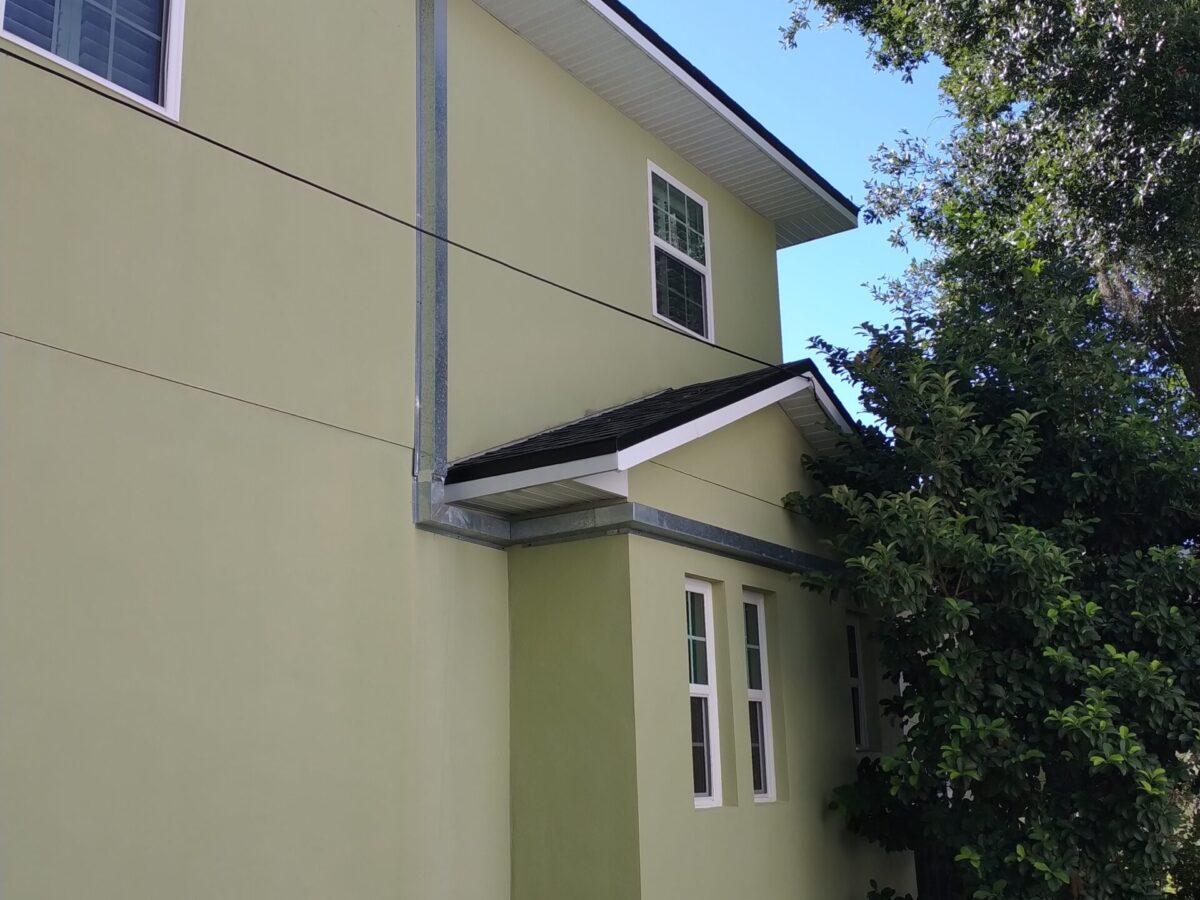 Professional exterior building cleaning near me in Celebration, FL maintaining columns beside a shaded covered walkway
